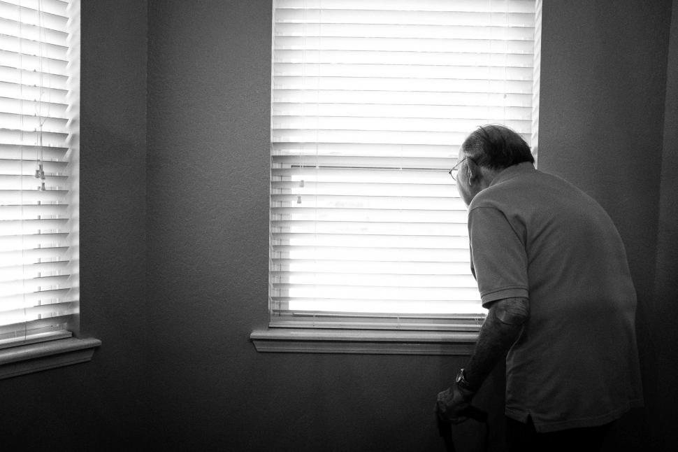 Free Image of Man Standing in Front of Two Windows 