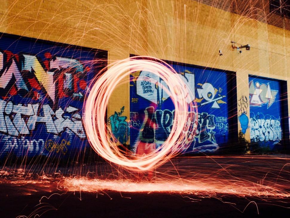 Free Image of Person Spinning Circular Object in Front of Building 