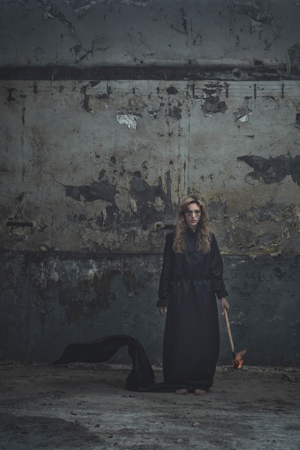 Free Image of Woman Standing in Dark Room With Knife 