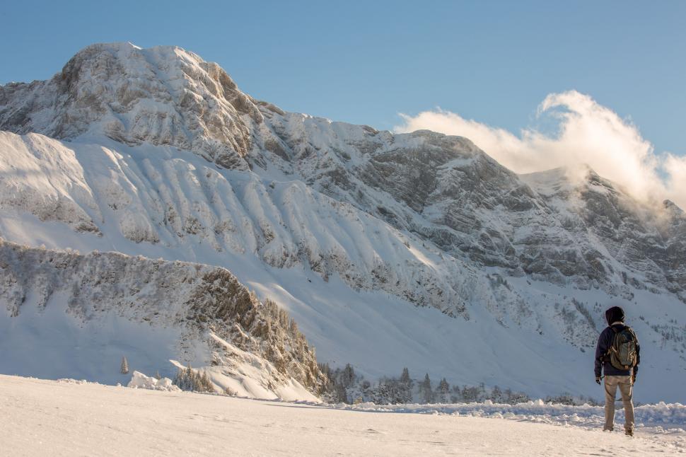Free Image of Man Standing on Snow Covered Slope 