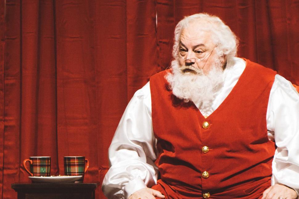 Free Image of Man in Red Vest Sitting at Table 