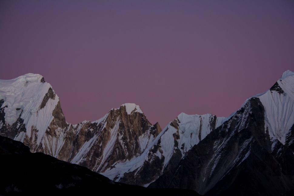 Free Image of Snow-Covered Mountain Range in Background 