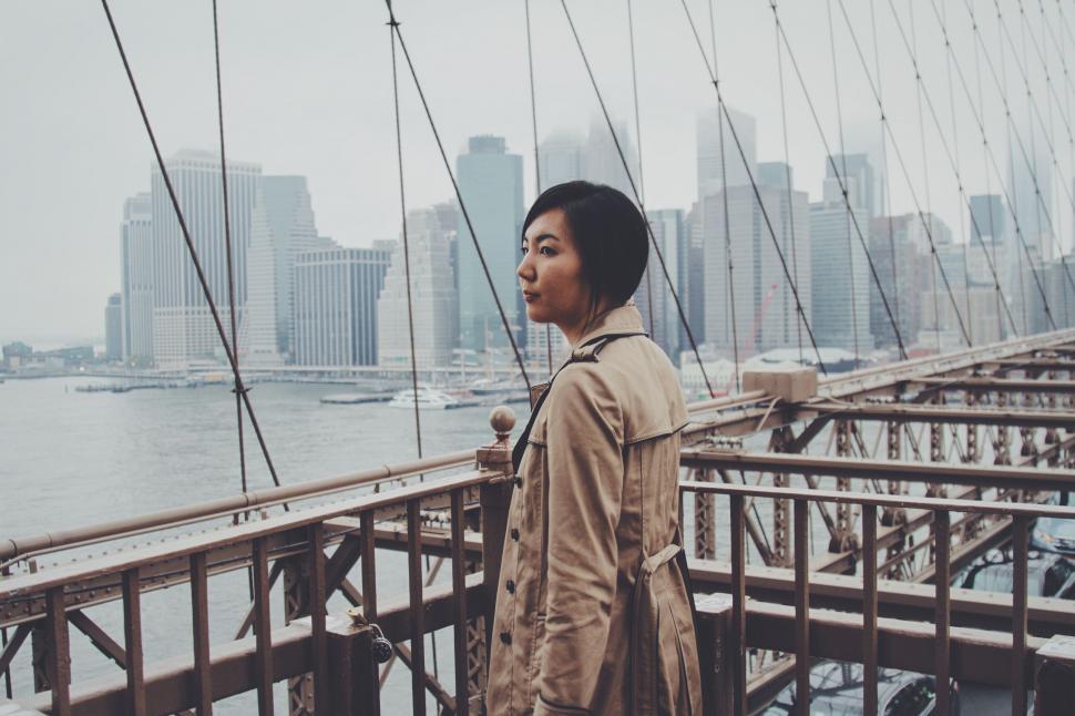 Free Image of Man Standing on Bridge Looking at Water 