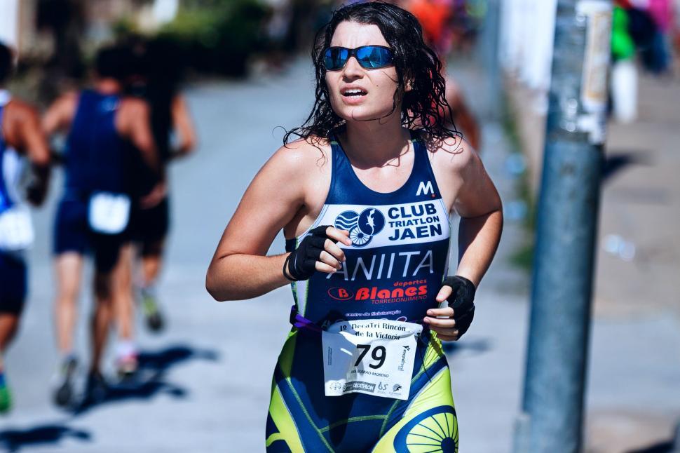 Free Image of Woman Running Down a Street in a Race 