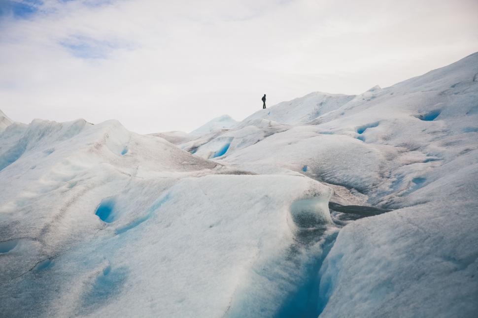 Free Image of Man Standing on Snow Covered Mountain Top 