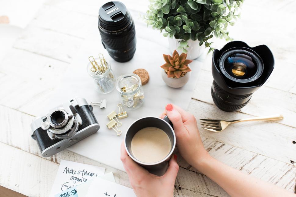 Free Image of Person Holding Cup of Coffee on Table 