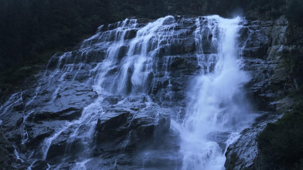 Free Image of Towering Waterfall Amidst Dense Forest 