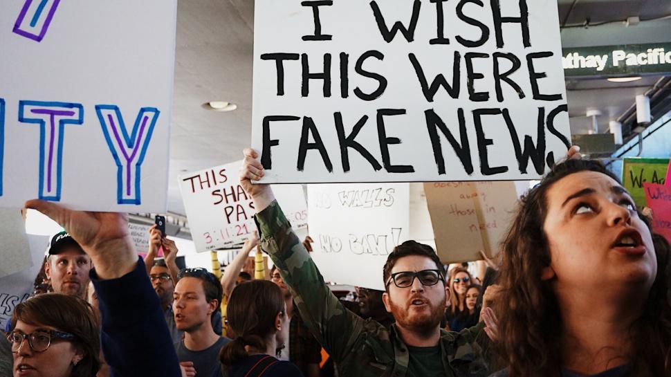Free Image of Group of People Holding Up Signs 