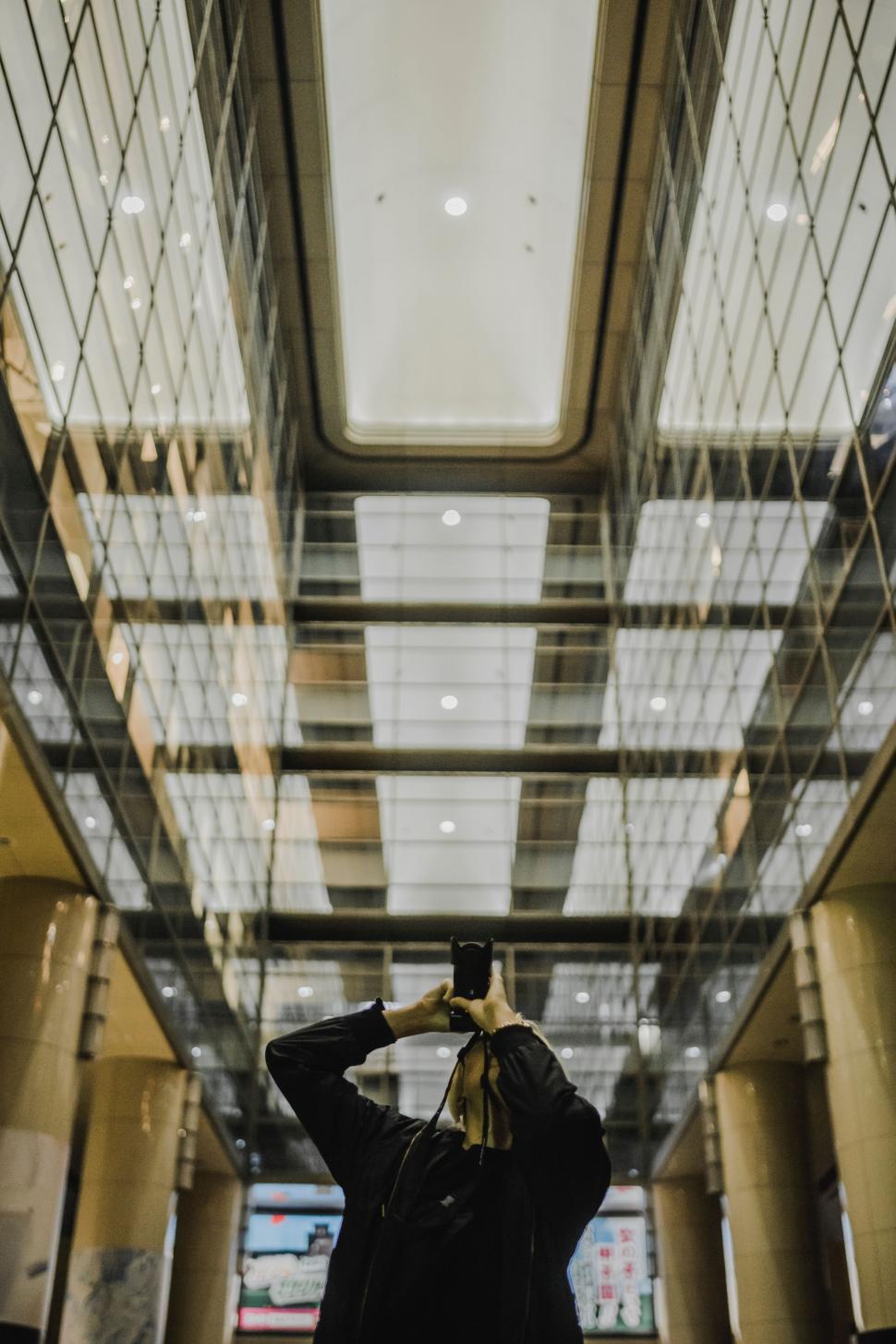 Free Image of Person Taking a Picture of a Building 