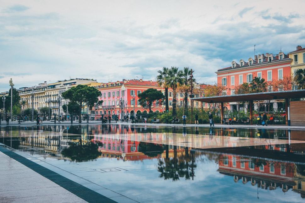 Free Image of Large Body of Water With Buildings in Background 