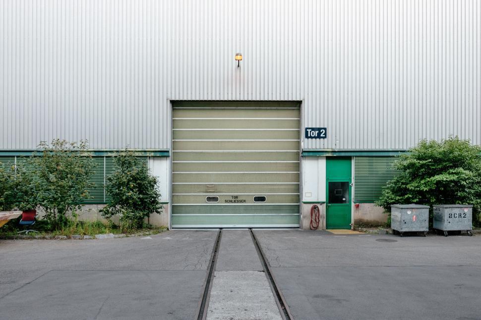 Free Image of Empty Parking Lot With Large Garage Door 