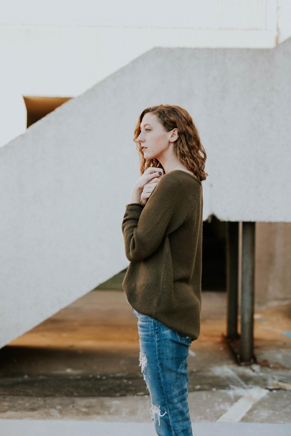 Free Image of Woman Standing in Front of Staircase 