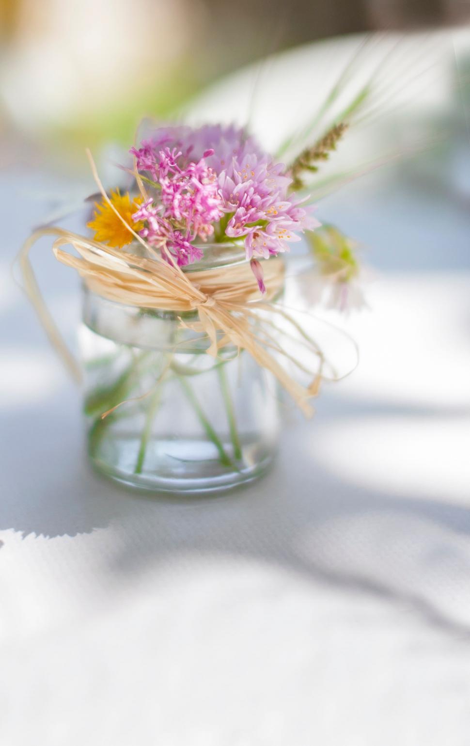Free Image of Glass Jar Filled With Flowers on Table 
