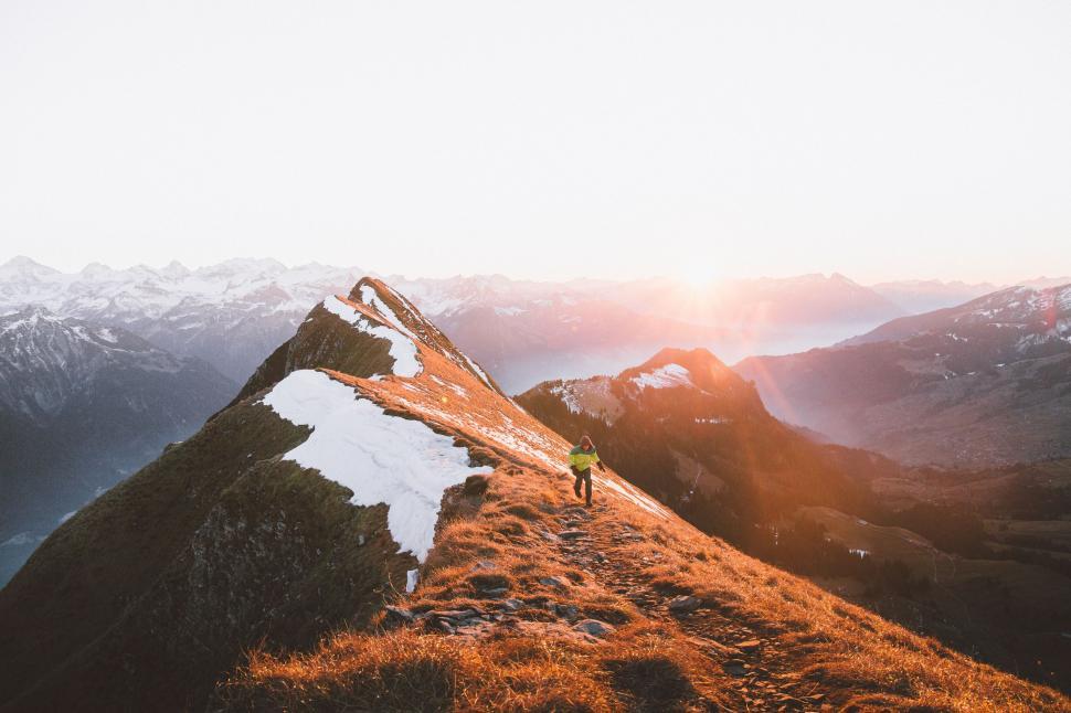 Free Image of Person Standing on Top of Snow Covered Mountain 