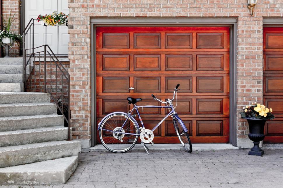 Free Image of Bicycle Parked in Front of Garage Door 