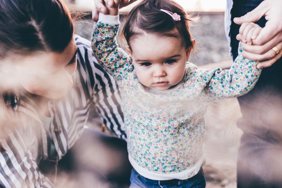 Free Image of Woman Holding Little Girl Up to Her Head 