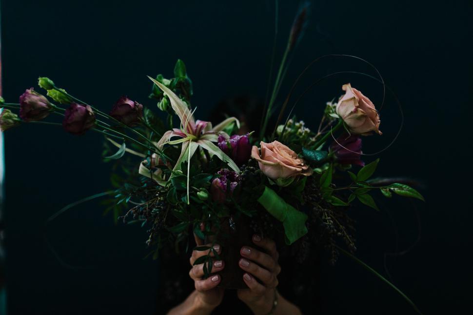 Free Image of Person Holding Bouquet of Flowers in Front of Mirror 