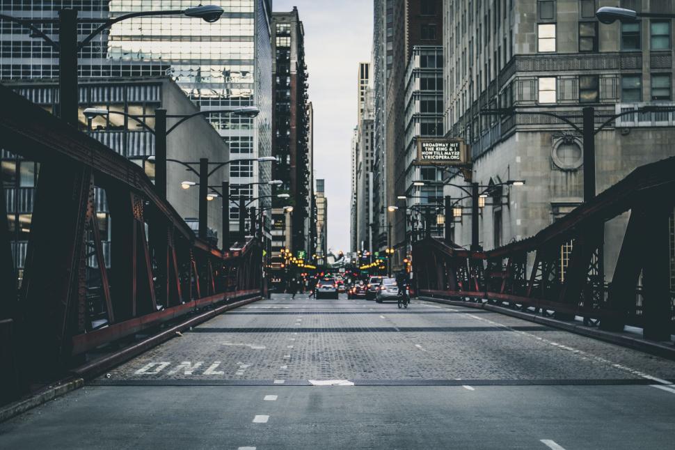 Free Image of Busy City Street With Tall Buildings and Traffic Lights 