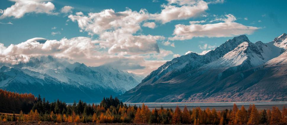 Free Image of Majestic Mountains Covered in Snow and Clouds 