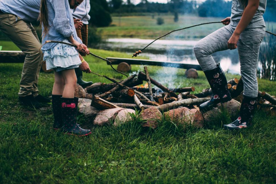 Free Image of People Standing Around a Campfire 
