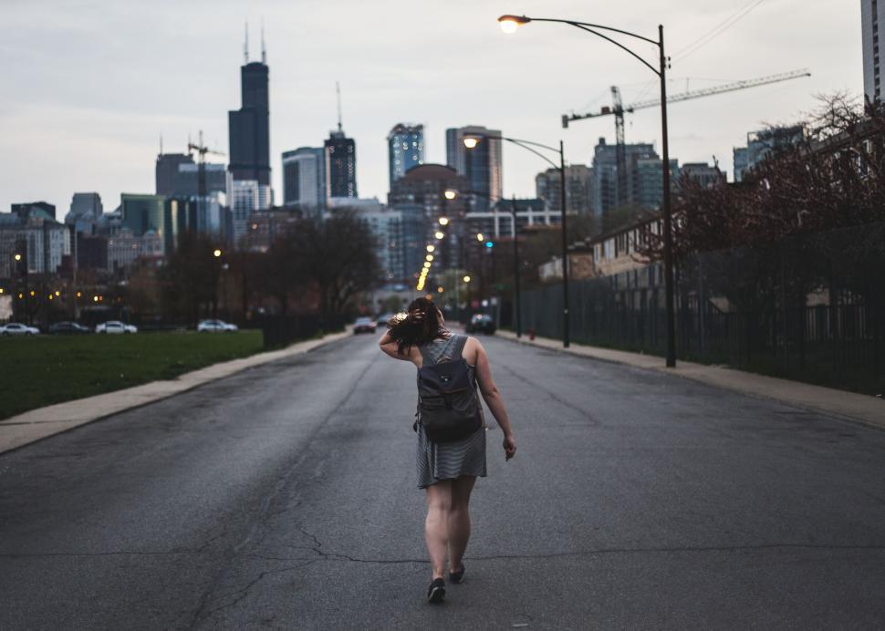 Free Image of Person Walking Down the Middle of a Street 