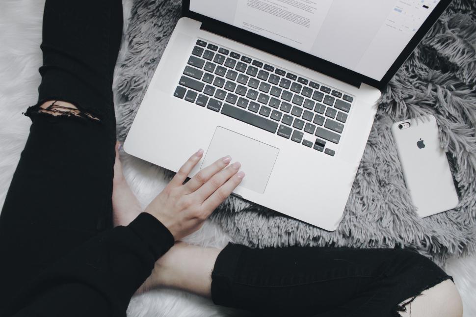 Free Image of Person Sitting on Bed Using Laptop 
