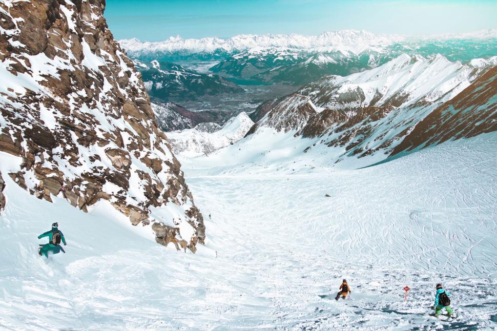 Free Image of Group of People Skiing Down Snow Covered Slope 