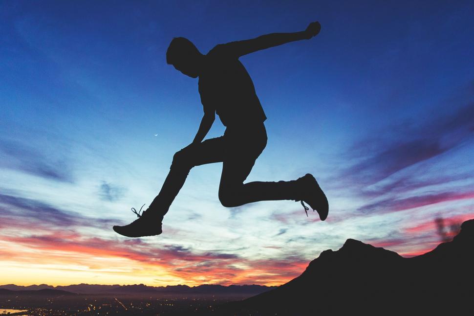 Free Image of Silhouette of a Man Jumping in the Air 