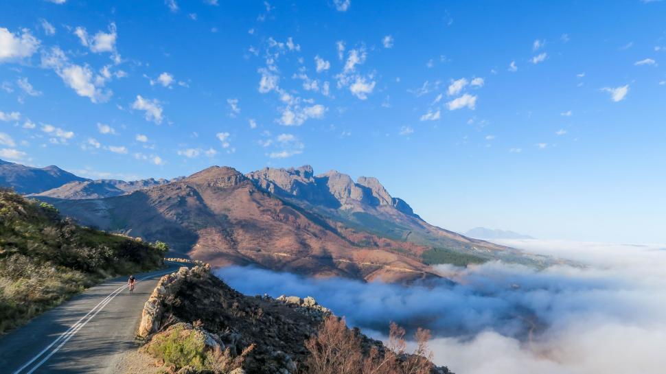 Free Image of Scenic Mountain Road With Low Lying Clouds 