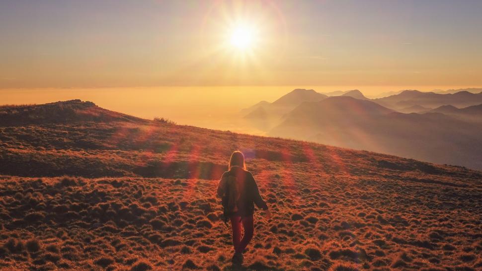 Free Image of Person Ascending Hill at Sunset 