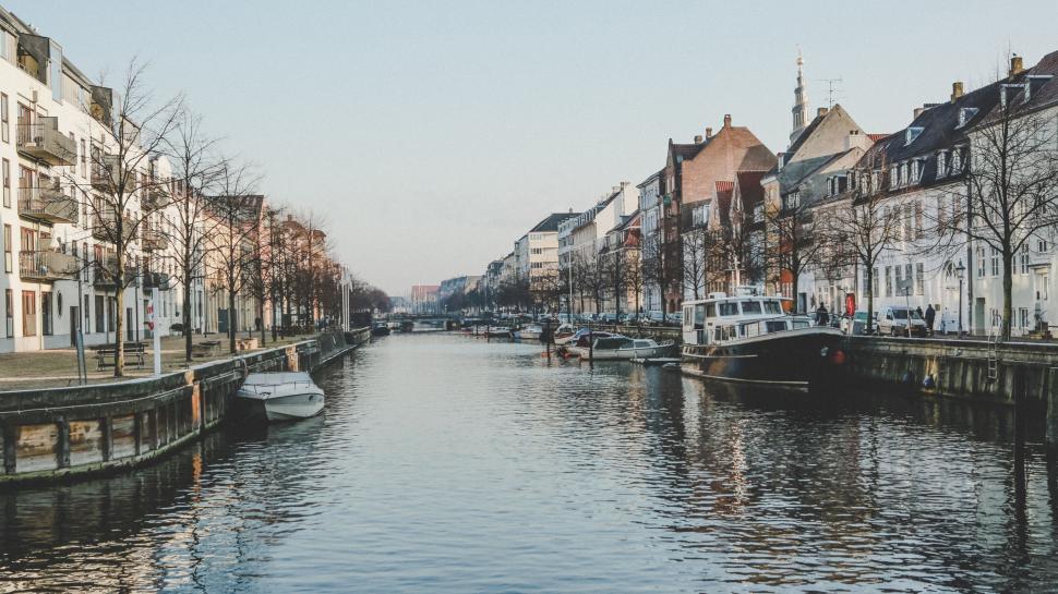 Free Image of River Running Through City Next to Tall Buildings 