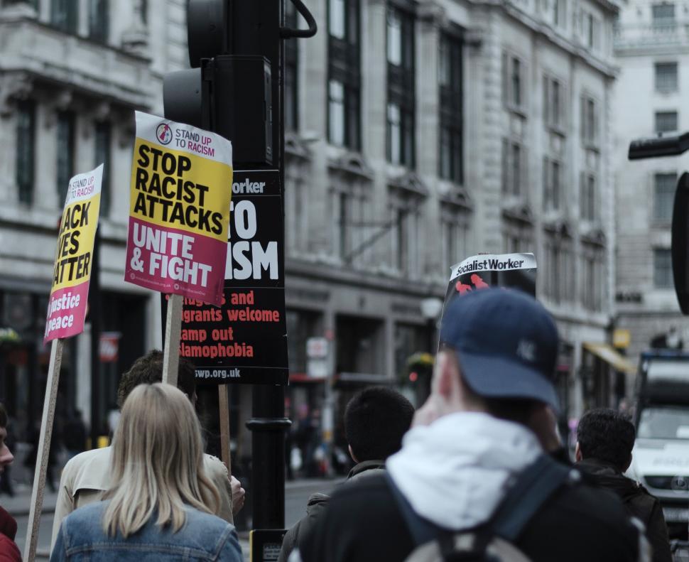 Free Image of Group of People Walking Next to Traffic Light 