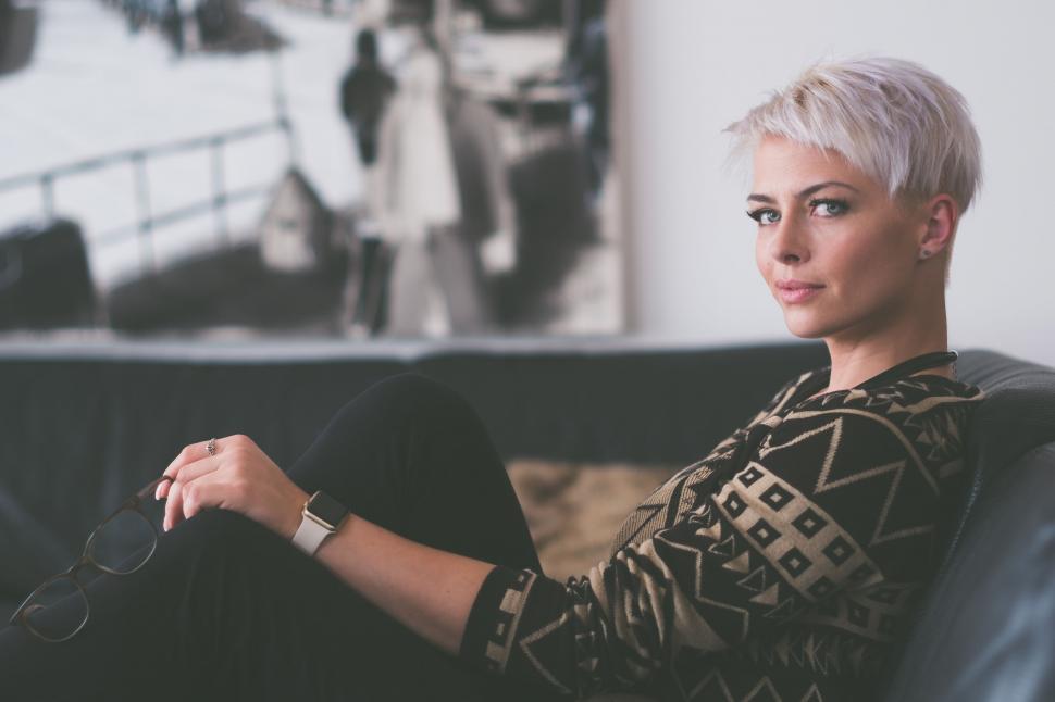 Free Image of Woman Sitting on Couch in Living Room 