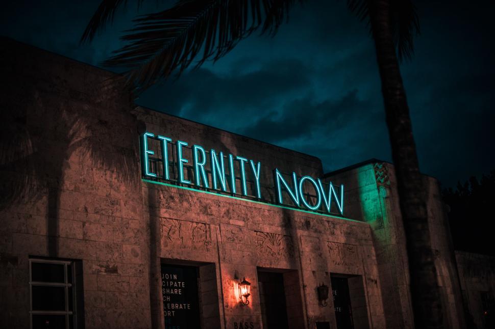 Free Image of Neon Sign Illuminating Building Facade 
