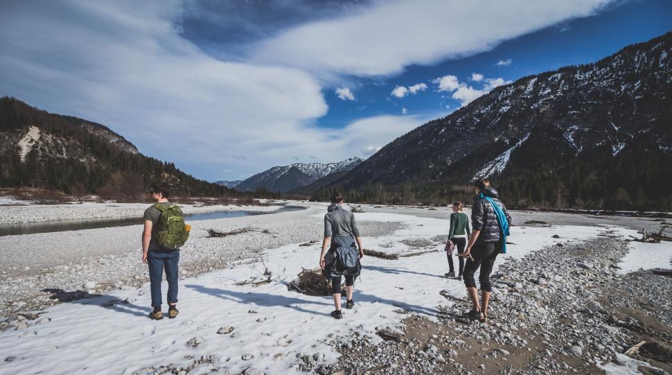 Free Image of Group of People Walking Across Snow Covered Field 