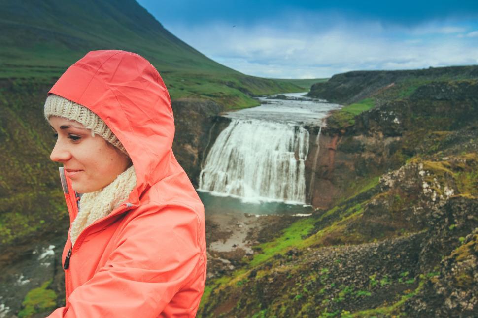 Free Image of Woman Standing in Front of Waterfall 
