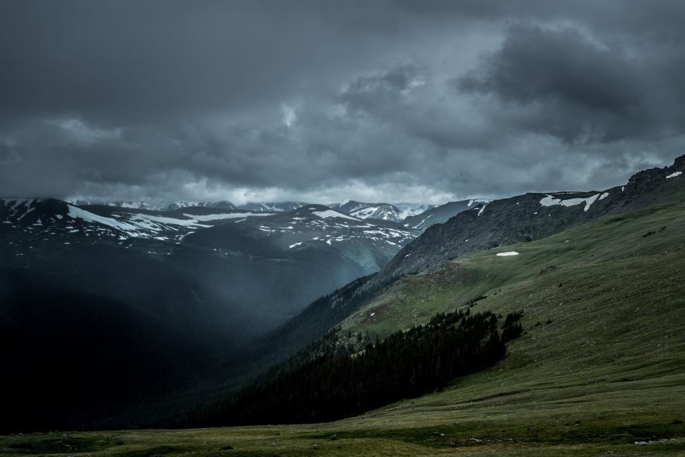Free Image of Grassy Field With Mountains in the Background 