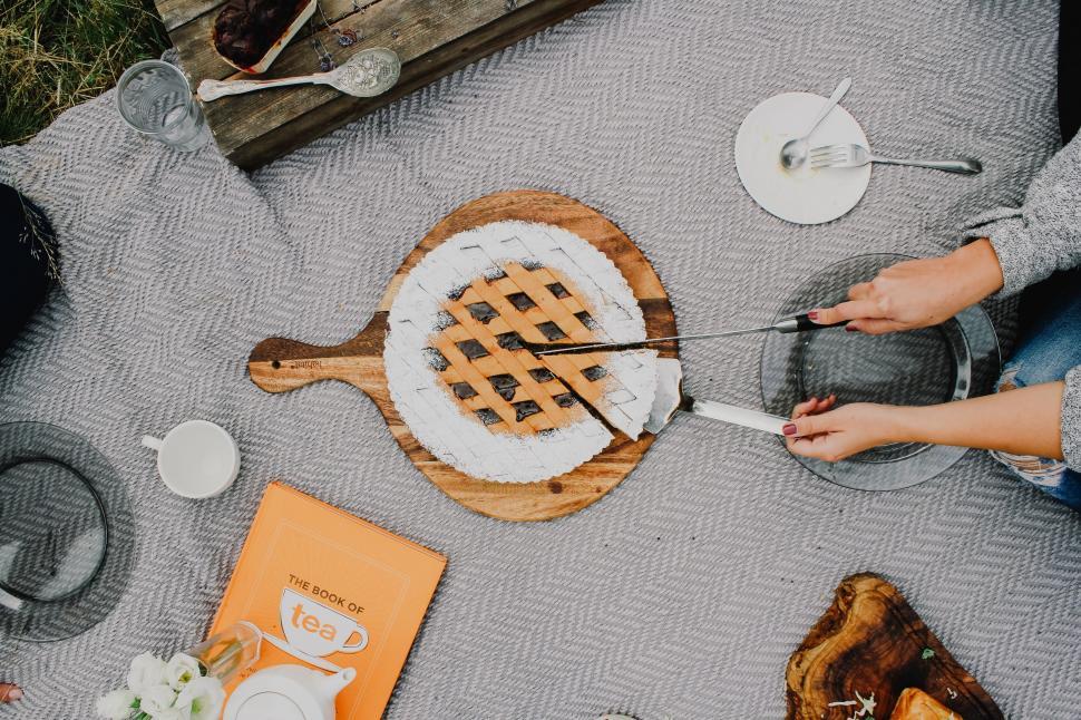 Free Image of Person Cutting Pie on Table 