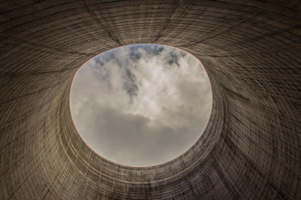 Free Image of Round Hole in Brick Wall Against Cloudy Sky 