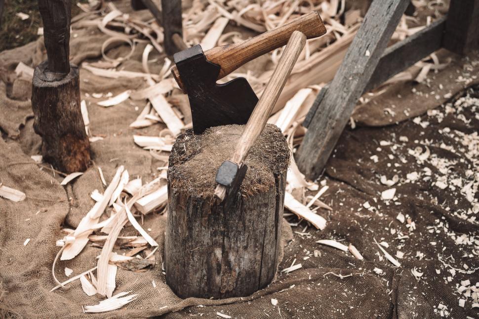 Free Image of Old Axe Among Pile of Wood 