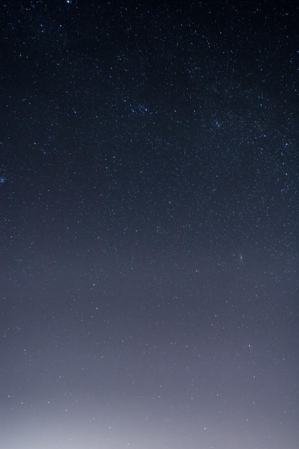 Free Image of Man Standing on Snow-Covered Slope Under Night Sky 