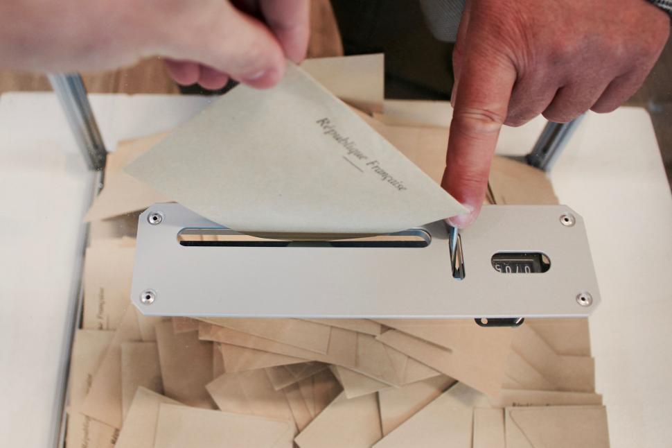 Free Image of Person Cutting Piece of Paper With Scissors 