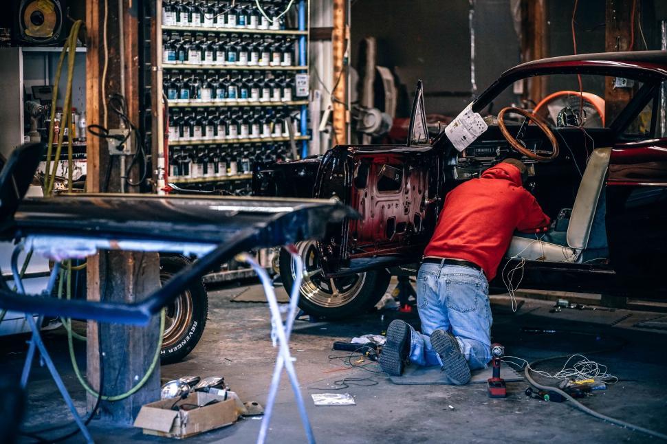 Free Image of Man Working on Car in Garage 