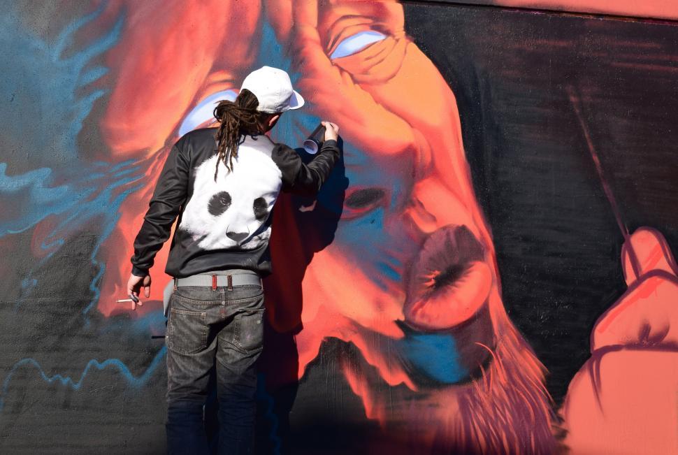 Free Image of Man Painting Mural on Wall 