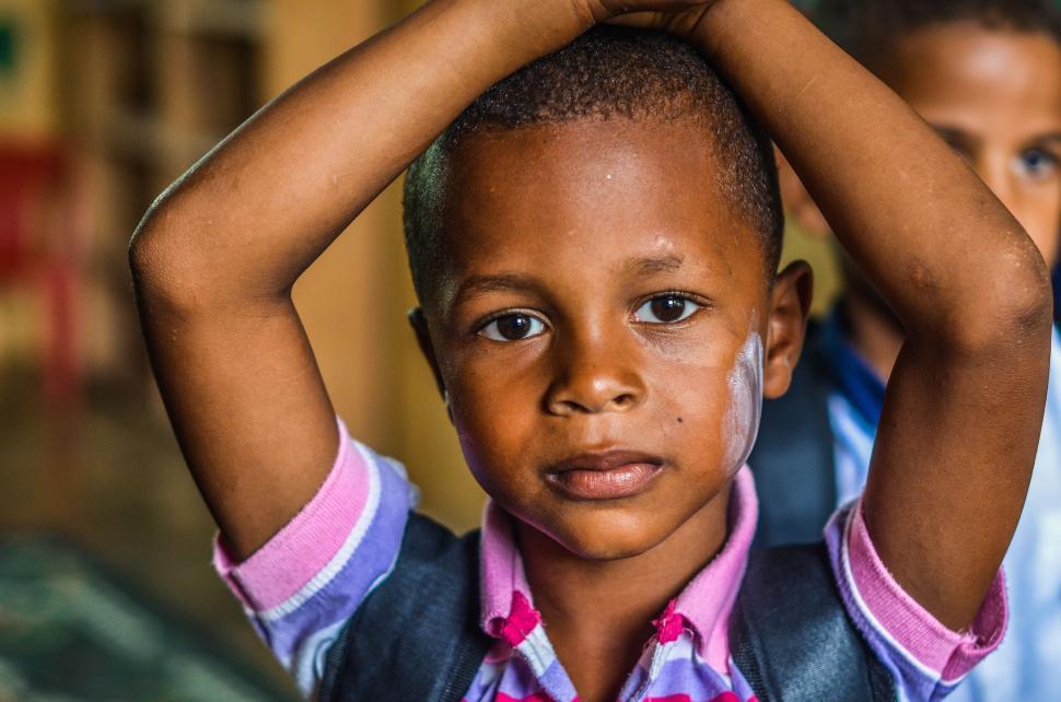 Free Image of Young Boy Holding Hands to Head 
