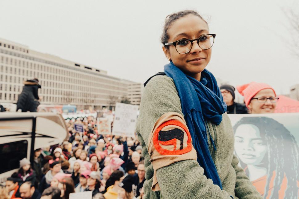 Free Image of Woman Standing Before Crowd of People 