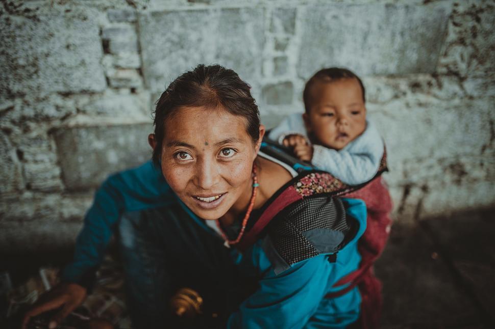 Free Image of Woman Carrying Baby on Back 