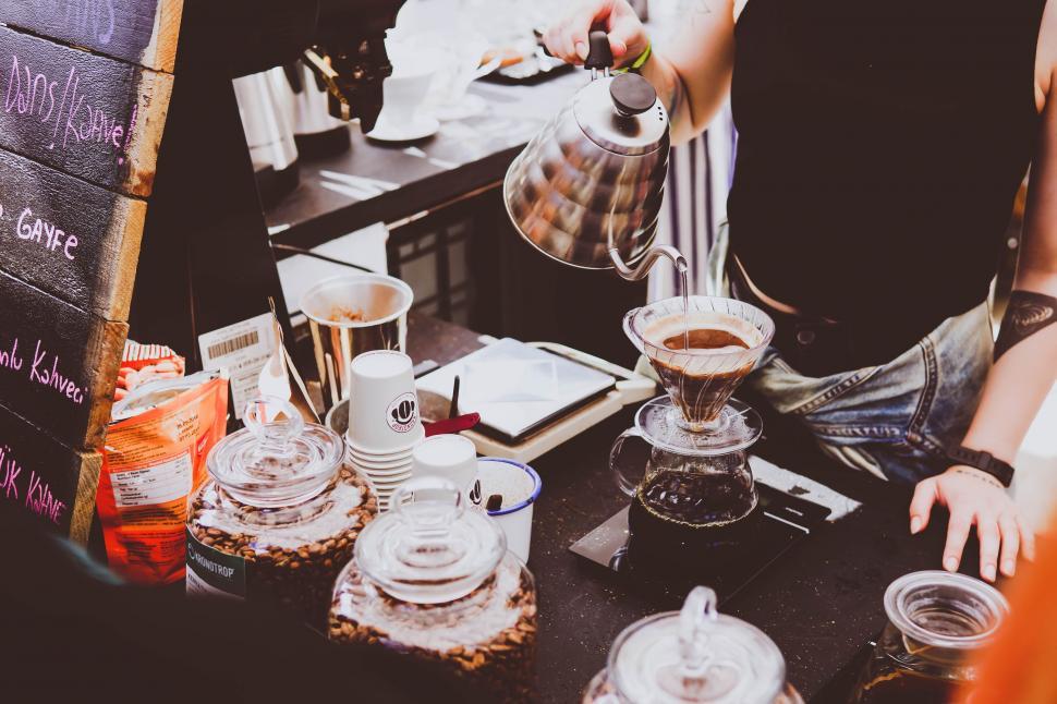 Free Image of Man Standing in Front of Counter With Cups and Saucers 