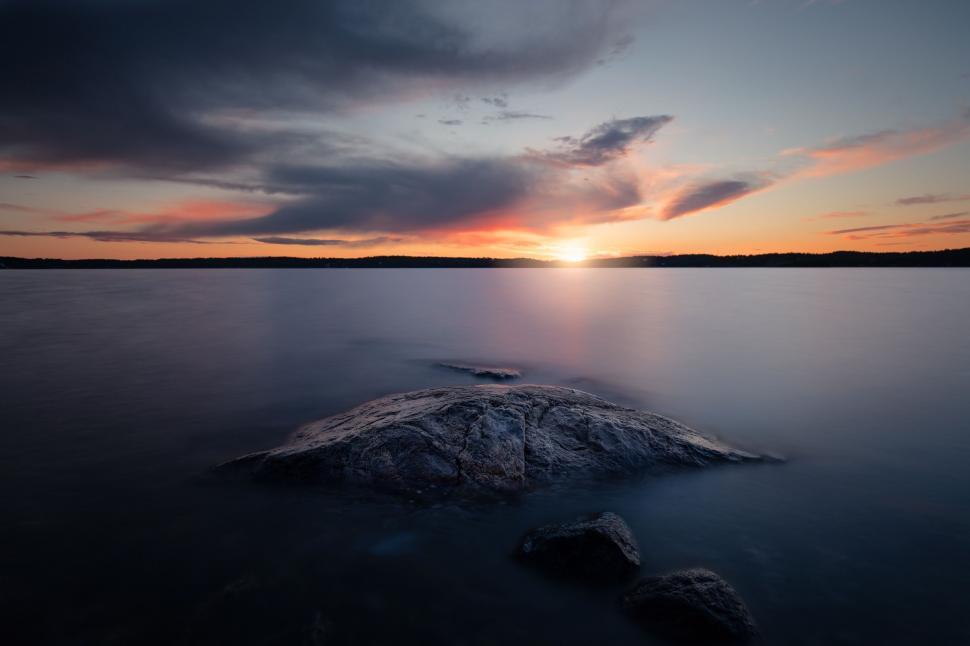 Free Image of Large Body of Water With Rock 
