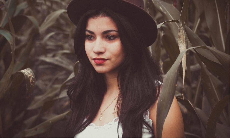 Free Image of Woman Wearing Hat Standing in Field 